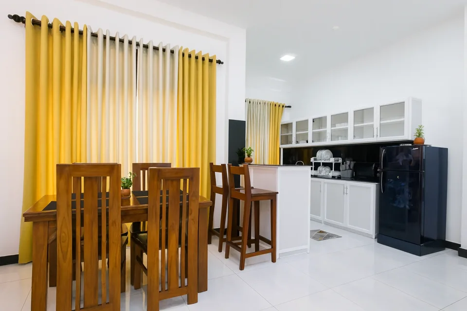 Wooden dining table beside the Katunayaka apartment kitchen