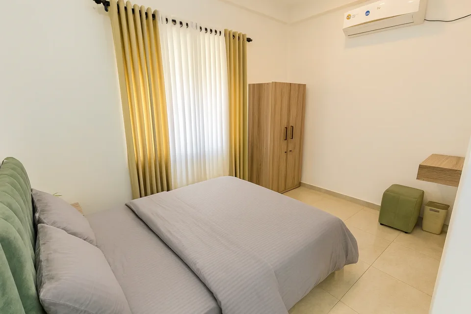Katunayaka first-floor bedroom showing the bed, wardrobe and dressing stool