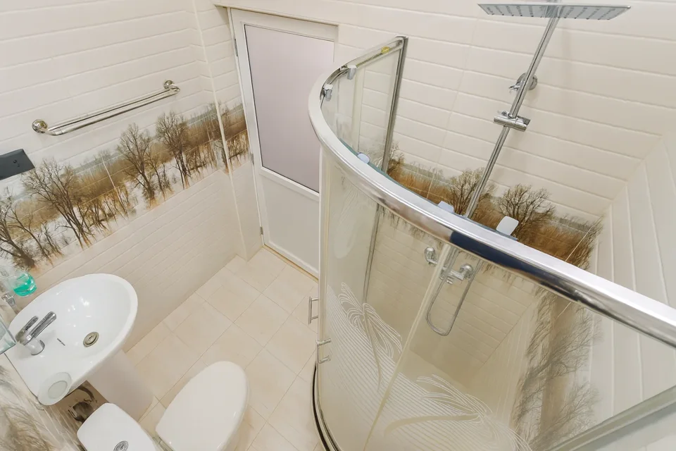 Katunayaka first-floor bathroom with a curved glass shower enclosure and basin