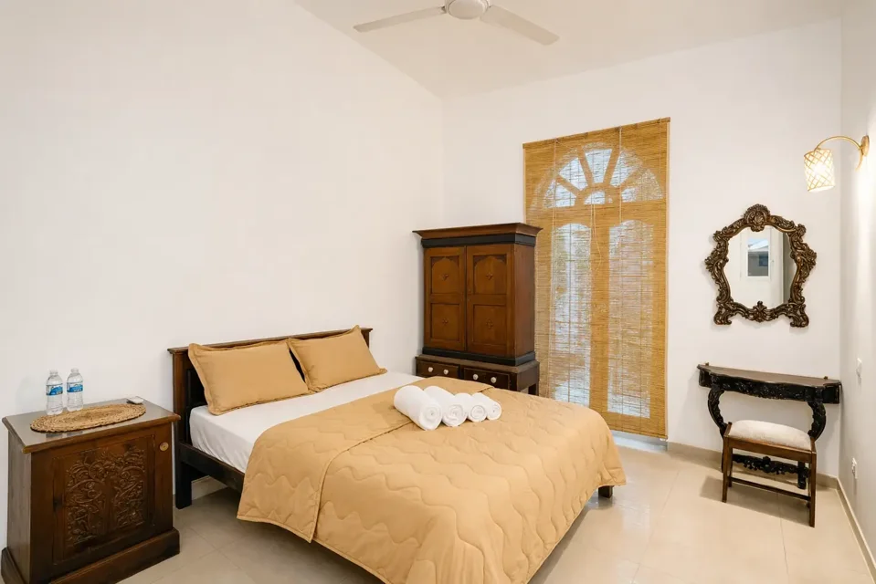 Comfort Double Room with a king bed, wooden wardrobe and mirror