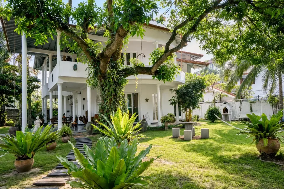 Skyport Villa Negombo behind a leafy garden and lawn