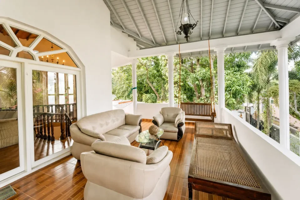 Covered sitting area at Skyport Villa Negombo overlooking trees