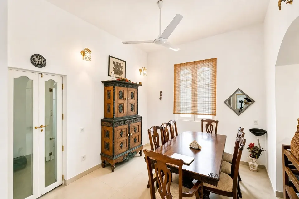 Negombo dining room with a wooden table, chairs and display cabinet