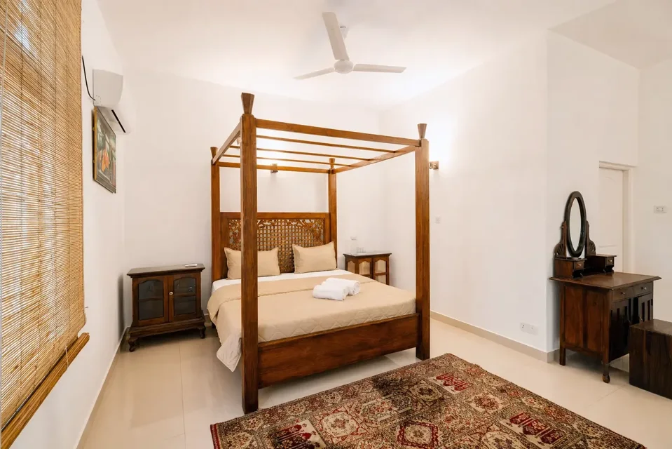 Ground Floor Double Room in Negombo with a wooden four-poster bed and dressing table