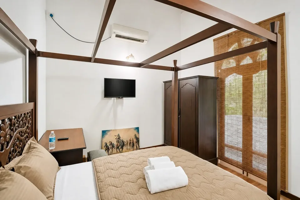 Garden Oasis Double Room showing the bed, wardrobe and television